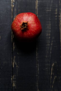 Siyah ahşap arka planda nar meyvesi. Boşluğu kopyala.