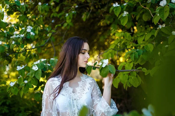漂亮的少女 穿着白色衣服 长长的黑头发 在苹果园里 春花与青春的概念 — 图库照片