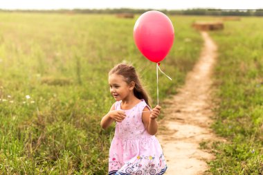 kız yaz aylarında doğa kırmızı balon ile çalışır