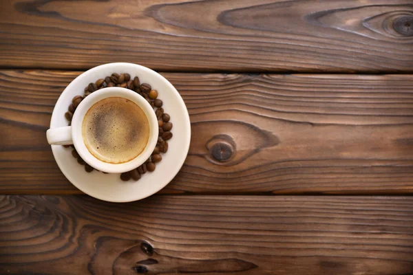 Cup of coffee on wooden table — Stock Photo, Image