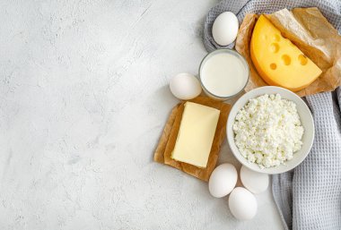 Süt ürünleri ve beyaz arka planda çiğ yumurta. Üst Manzara. Boşluğu kopyala.