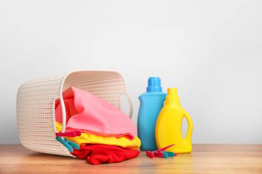 Deterjan, beyaz duvarda çamaşır tozu ve havlu.