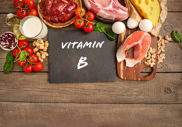 Sortiment Höga Vitamin Källor Trä Bakgrund Mjölk Lever Olivolja Tomater — Stockfoto