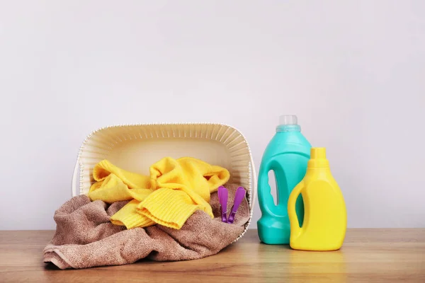 Detergent with washing powder and towels over white wall