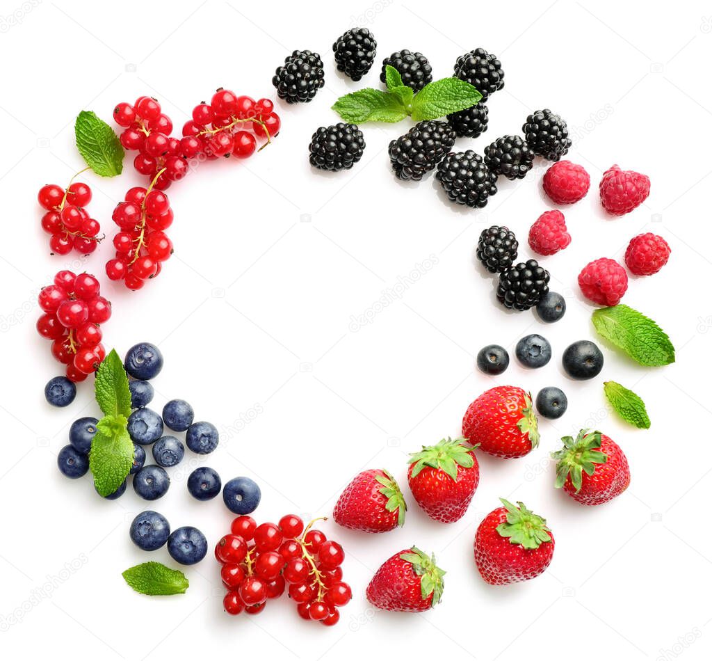 Circle frame of assorted wild fresh berries isolated on white background. Top view. Copy space.
