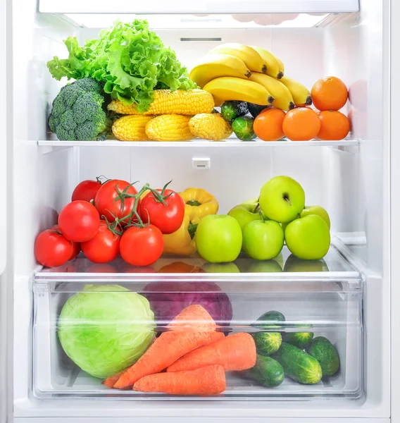 Open fridge full of vegetables and fruits