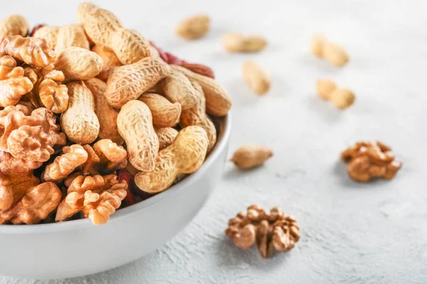 Mixed nuts Mixed nuts in white ceramic bowl on white background.