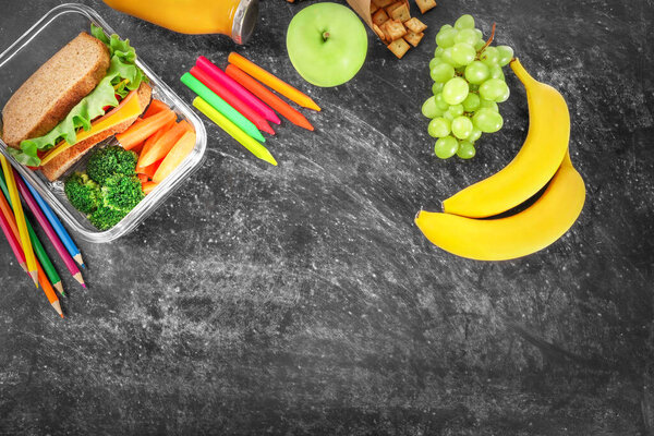 Healthy school lunch on black chalkboard background. Top view. Copy space.