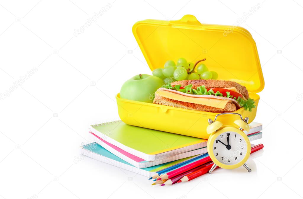 Healthy school lunch box and school stationery isolated on white background.