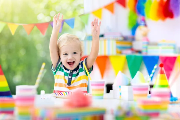 子供の誕生日パーティー カラフルなケーキの上のろうそくを吹きの子 虹旗バナー 風船で飾られた家 ファーム動物のテーマにお祝いします 小さな少年の祝う誕生日 パーティー フード — ストック写真