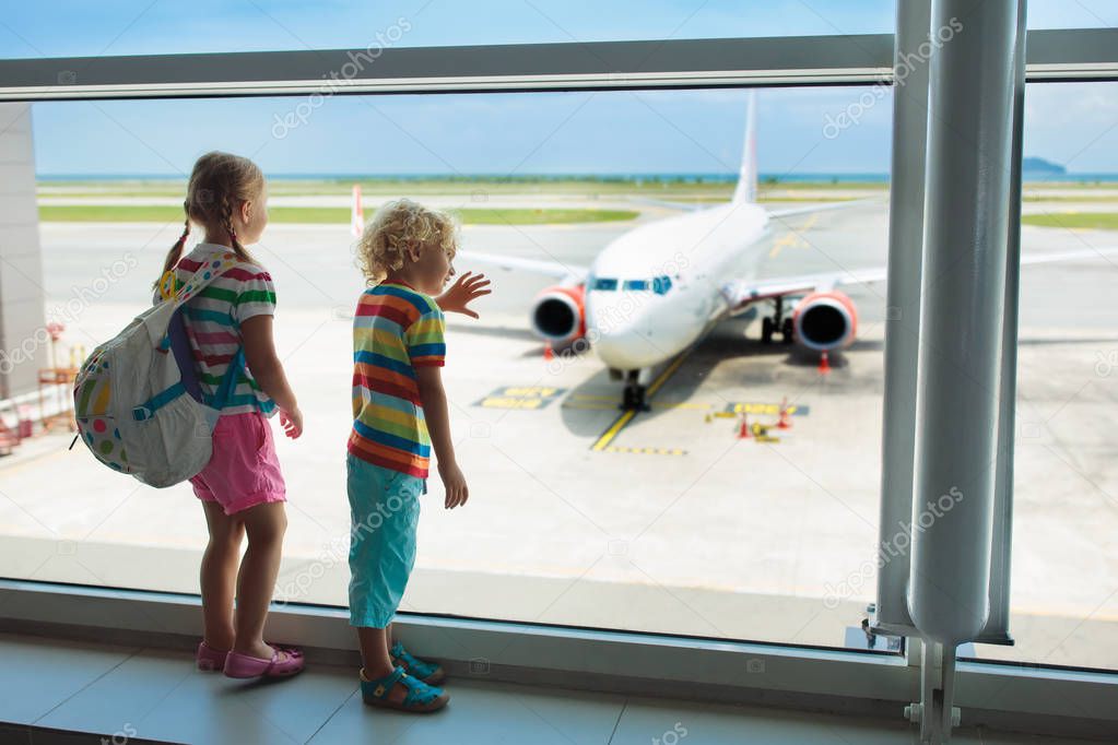 Kids at airport. Children look at airplane. Traveling and flying with child. Family at departure gate. Vacation and travel with young kid. Boy and baby before flight in terminal. Kids fly a plane.