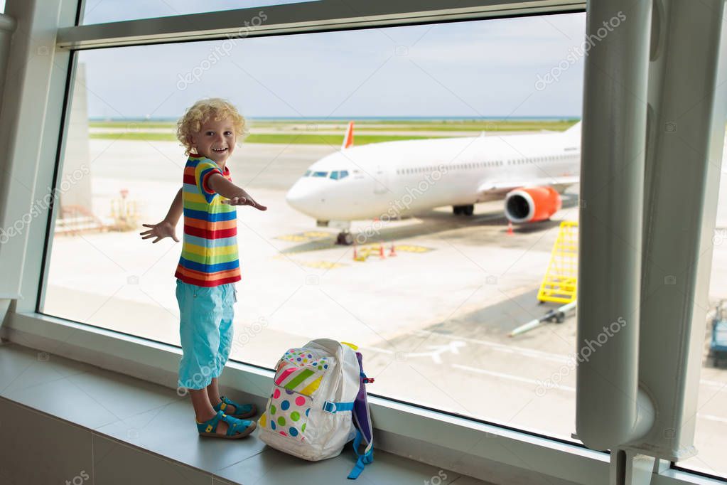 Kids at airport. Children look at airplane. Traveling and flying with child. Family at departure gate. Vacation and travel with young kid. Little boy before flight in terminal. Kids fly a plane.