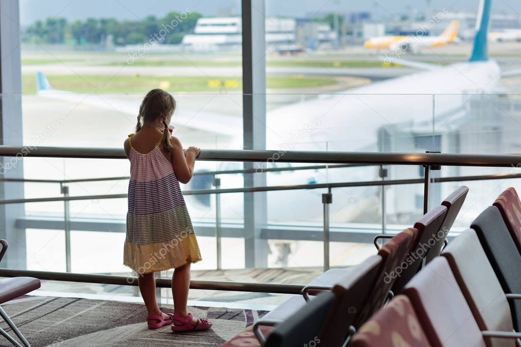 Kids at airport. Children look at airplane. Traveling and flying with child. Family at departure gate. Vacation and travel with young kid. Little girl before flight in terminal. Kids fly a plane.