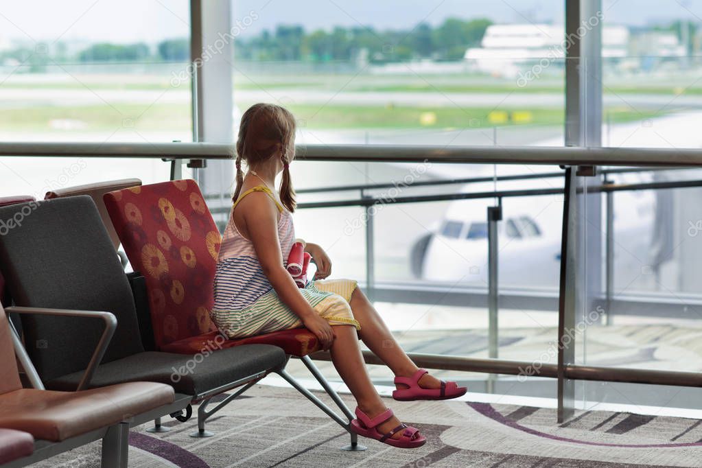Kids at airport. Children look at airplane. Traveling and flying with child. Family at departure gate. Vacation and travel with young kid. Little girl before flight in terminal. Kids fly a plane.