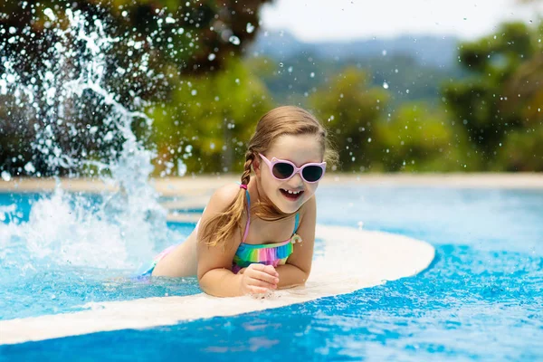 子供たちはプールで遊んでいる 子供たちと夏休み 熱帯の島のリゾートでエキゾチックな休日の間に水に飛び込む小さな女の子 子供たちは泳ぐ 未就学児のためのアクティブな屋外スポーツ — ストック写真
