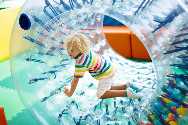 Child play in roller wheel. Kids on trampoline. — Stock Photo, Image