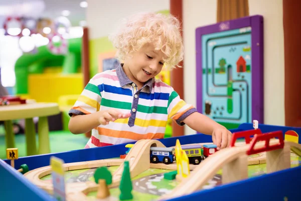 Kids play wooden railroad. Child with toy train. — Stock Photo, Image