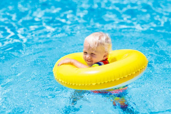 Niño en piscina en anillo de juguete. Niños nadan . — Foto de Stock