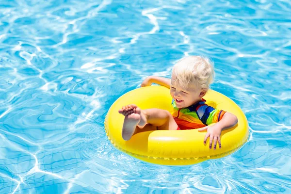 Niño en piscina en anillo de juguete. Niños nadan . — Foto de Stock