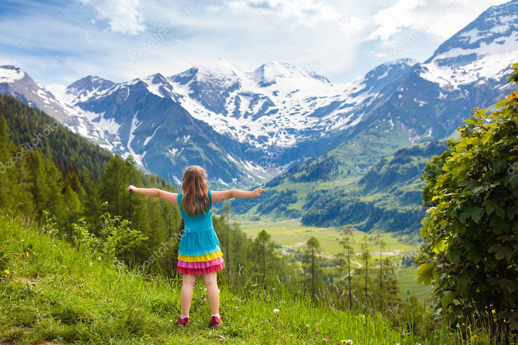 Children hiking in Alps mountains. Kids outdoor.