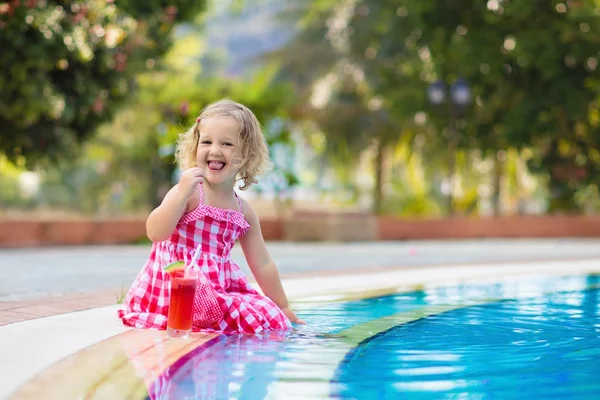 Gadis kecil minum jus di kolam renang — Stok Foto