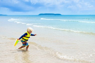 Çocuk tropik sahilde. Deniz tatil çocuklarla.