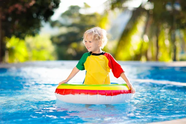 Niño en piscina en anillo de juguete. Niños nadan . — Foto de Stock