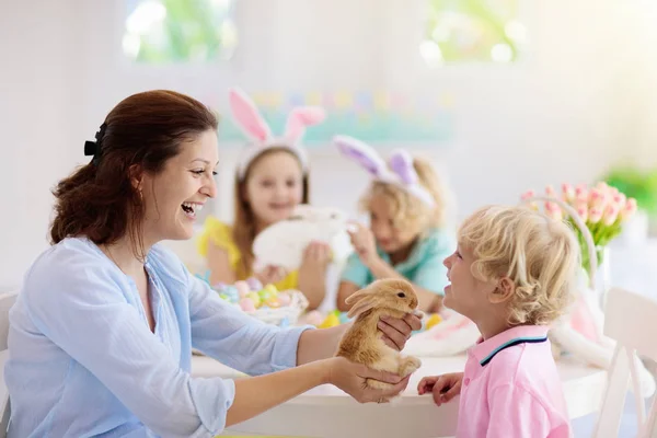 Mother and kids, family coloring Easter eggs. — Stock Photo, Image