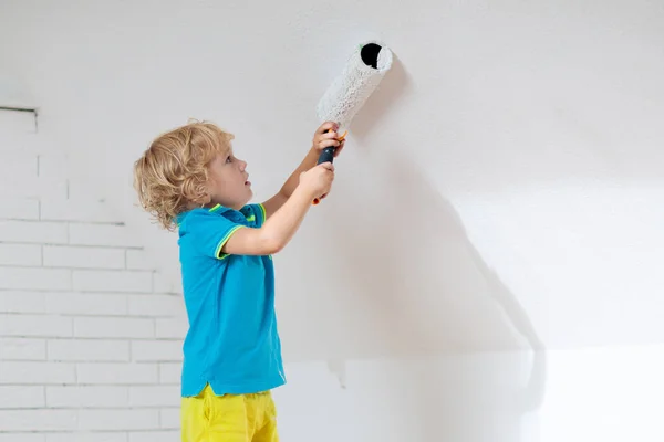 Kids painting attic wall. Home improvement. — Stock Image Kids painting attic wall. Home improvement. Royalty Free Stock Images