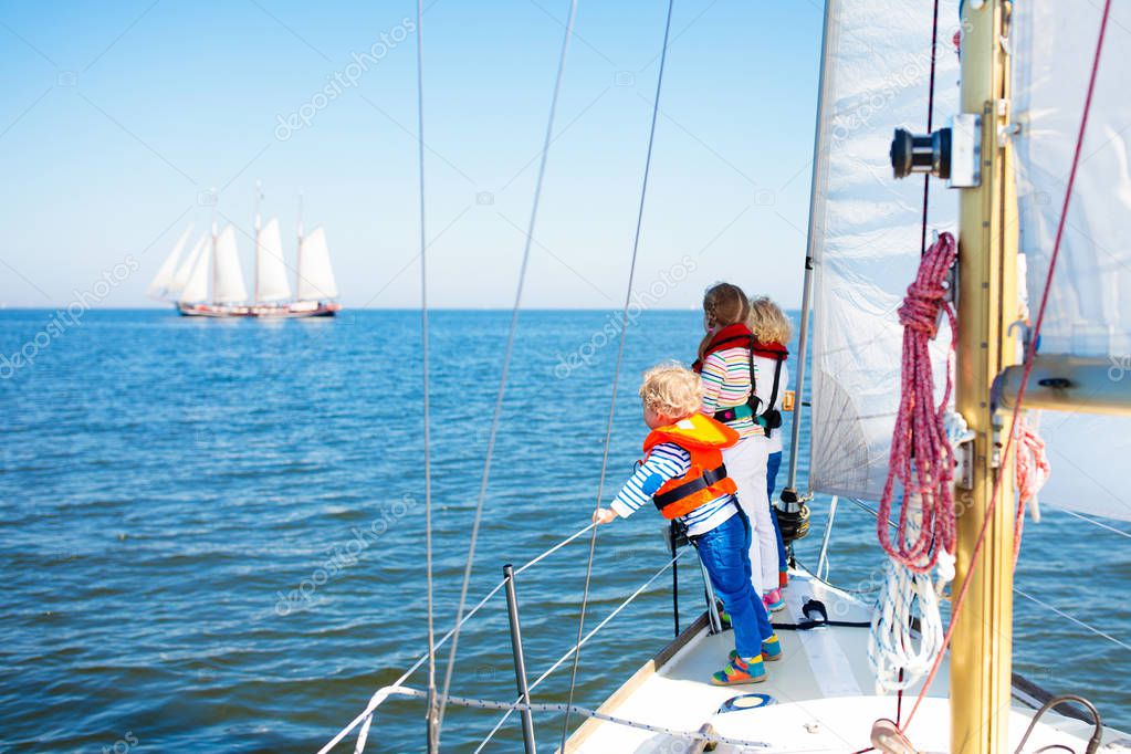 Kids sail on yacht in sea. Child sailing on boat.