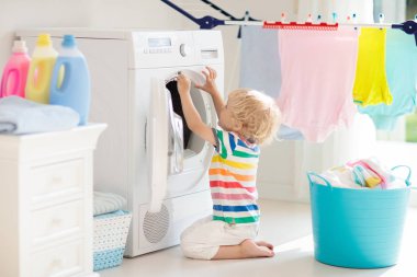 Child in laundry room with washing machine clipart