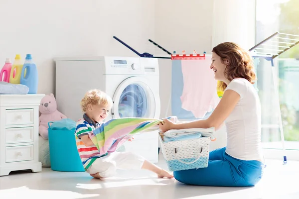 Família na lavanderia com máquina de lavar roupa — Fotografia de Stock
