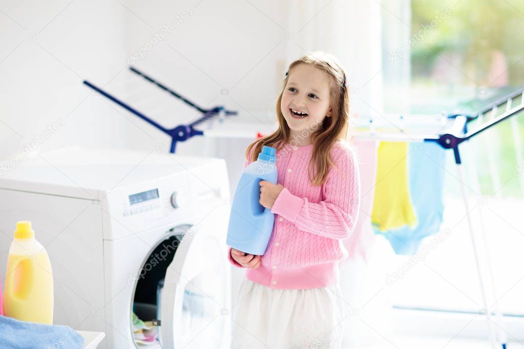 Child in laundry room with washing machine
