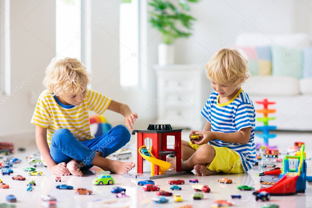 Kids play with toy cars. Children playing car toys