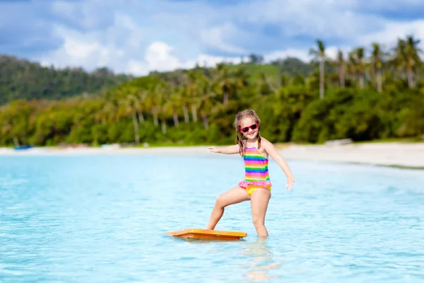 Kids surf on tropical beach. Vacation with child. Royalty Free Stock Images