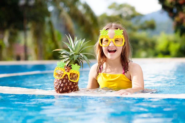 Child with pineapple in swimming pool. Kids swim. — Stock Photo, Image