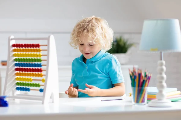 Child with abacus doing homework after school. — Stock Photo, Image