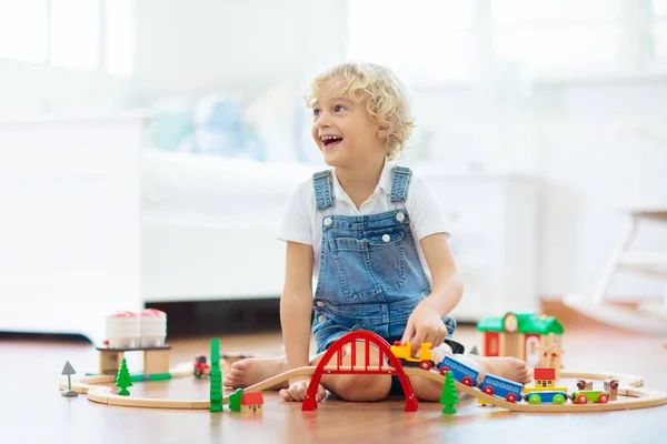 Kids play wooden railway. Child with toy train. — Stock Photo, Image