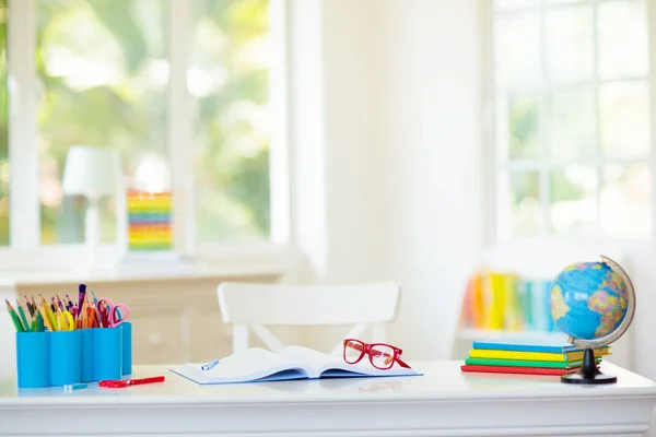 Back to school. Kids desk with books, globe. — Stock Photo, Image