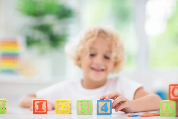 Lettres d'apprentissage pour enfants. Enfant avec blocs abc en bois — Photo