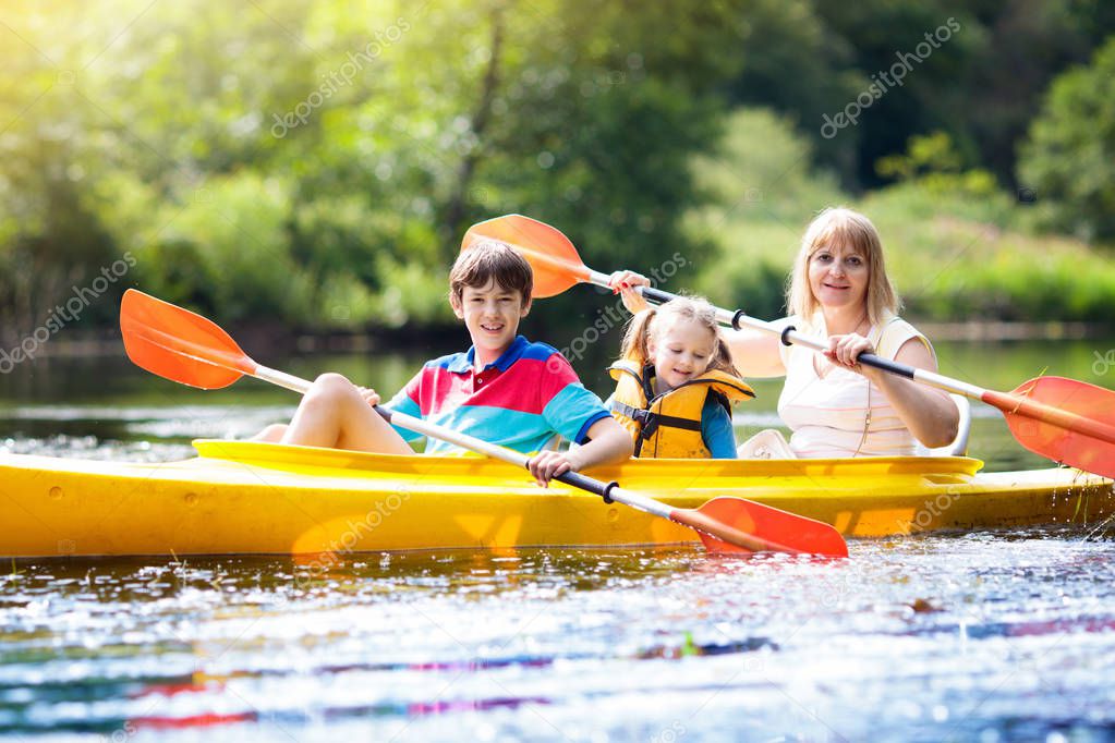 Child on kayak. Kids on canoe. Summer camping.