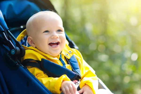 Baby boy in stroller in autumn park — Stock Photo, Image
