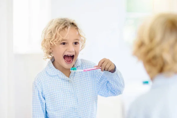 Lavarsi i denti ai bambini. Bambini con dentifricio, spazzolino . — Foto Stock