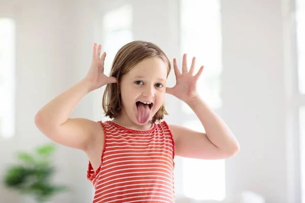Child funny face. Kid teasing. Girl laughing. — Stock Photo, Image