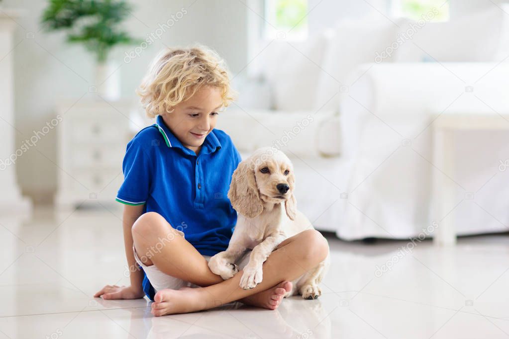 Child playing with dog. Kids play with puppy.