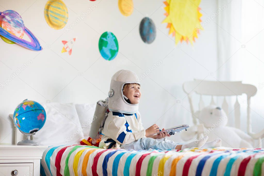 Kids play astronaut. Space and planet child game.