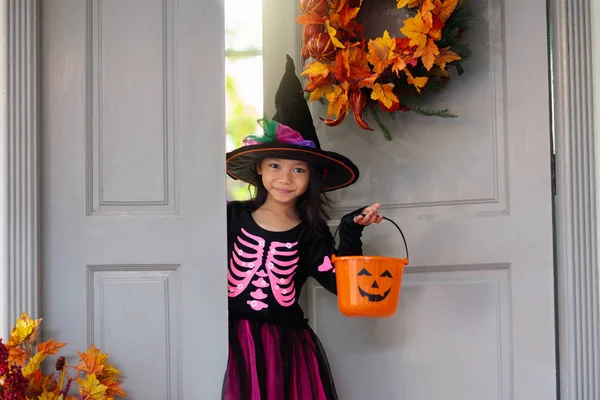 Kids trick or treat. Halloween. Child at door.