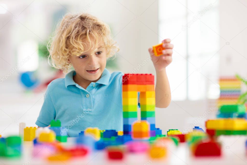 Child playing with toy blocks. Toys for kids.