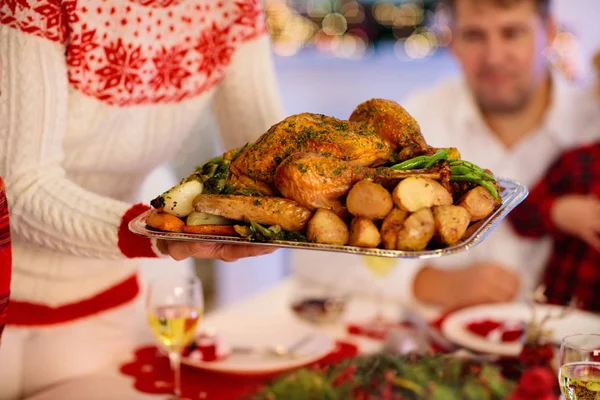 Family with kids having Christmas dinner at tree — Stock Photo, Image