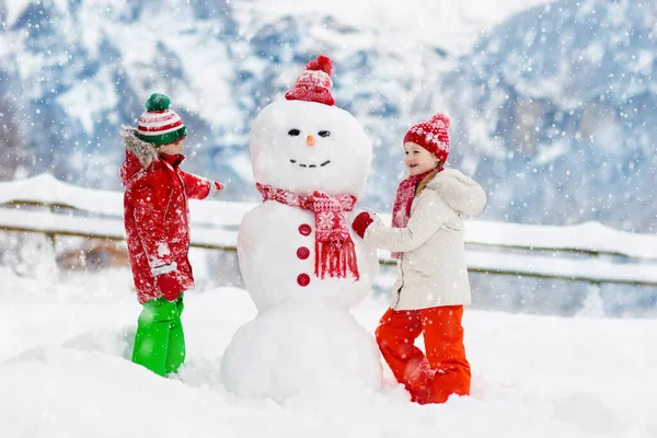 Child Building Snowman Kids Build Snow Man Boy Girl Playing — Stock Photo, Image